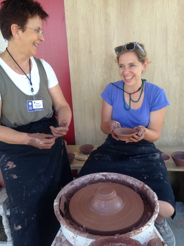 SarahVictoria learning how to make a clay bowl on the Festival grounds from Basque pottery master Blanka Gomez de Segura.